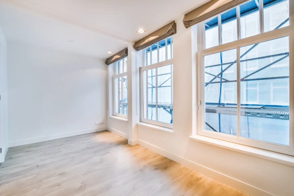 A luxurious interior of a room with large three windows.